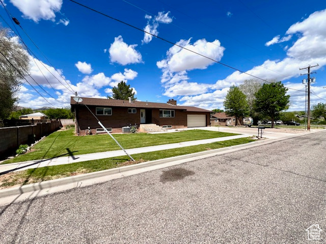 Ranch-style home featuring driveway and an attached garage
