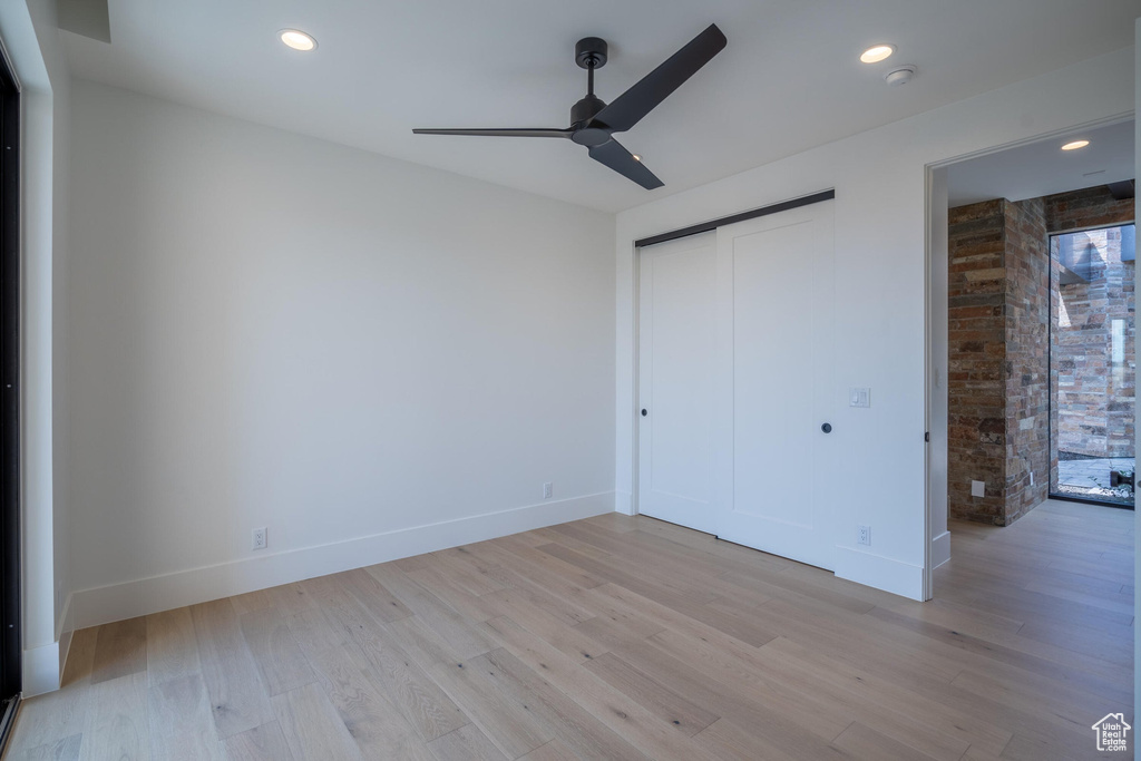 Unfurnished bedroom with ceiling fan, a closet, and light hardwood / wood-style flooring
