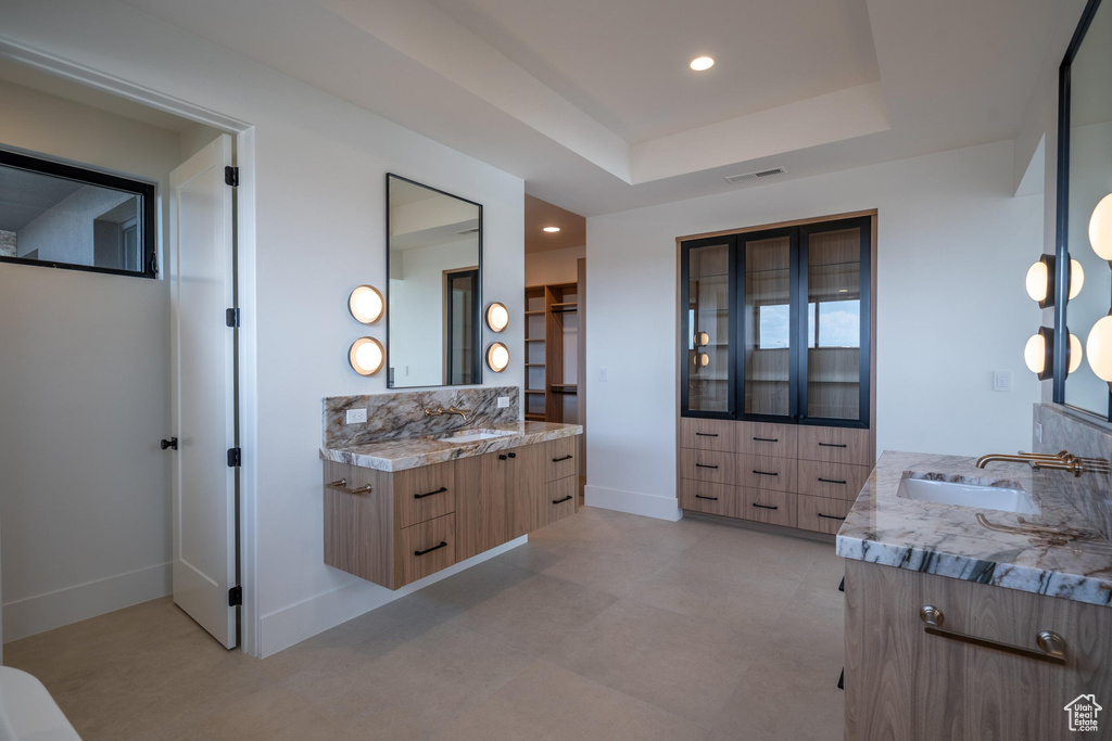 Bathroom with vanity and a tray ceiling