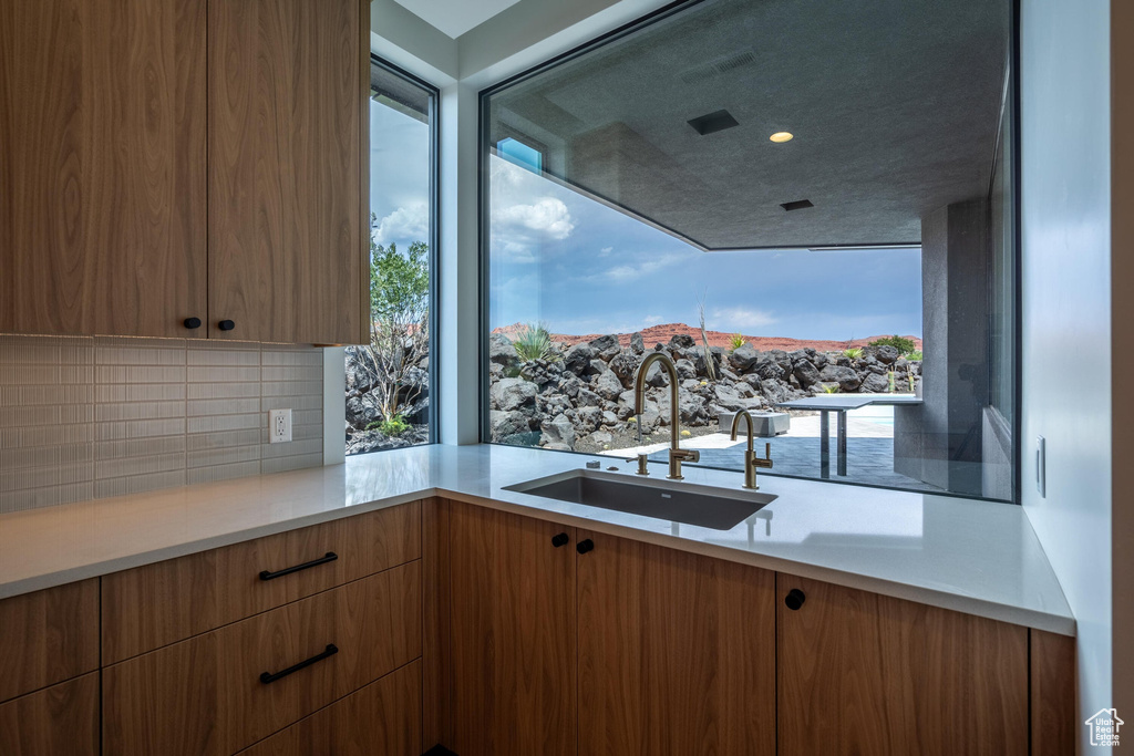 Kitchen featuring backsplash, a mountain view, and sink