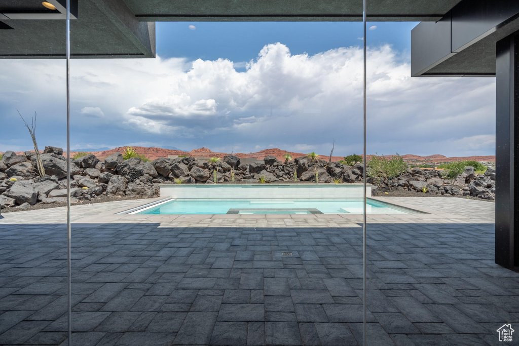 View of swimming pool featuring a mountain view and a patio area