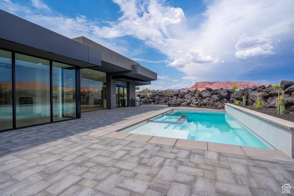 View of pool with a mountain view