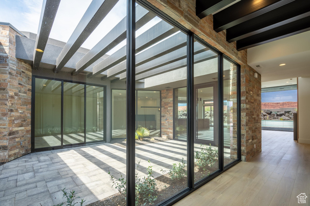 Unfurnished sunroom with beam ceiling