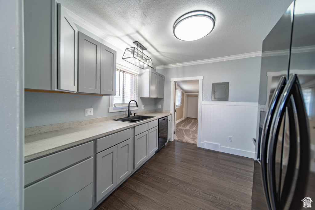 Kitchen with sink, hanging light fixtures, stainless steel fridge, gray cabinets, and black dishwasher