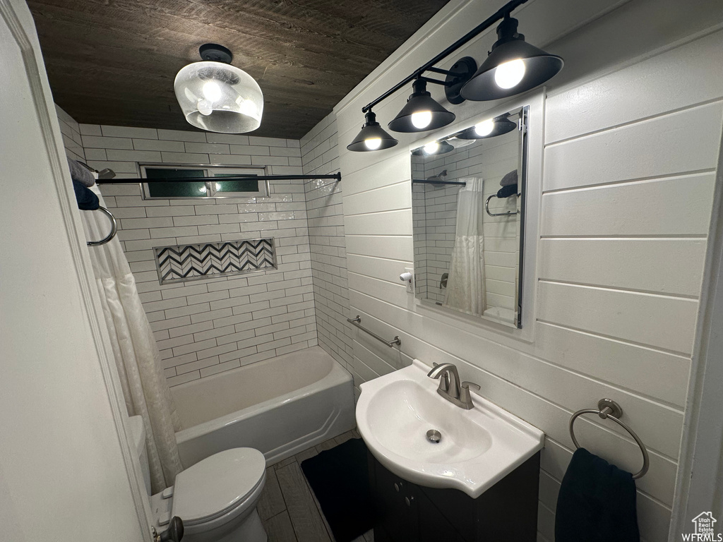 Full bathroom with wood walls, shower / bathtub combination with curtain, wooden ceiling, and toilet