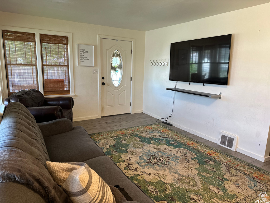 Living room with dark hardwood / wood-style flooring