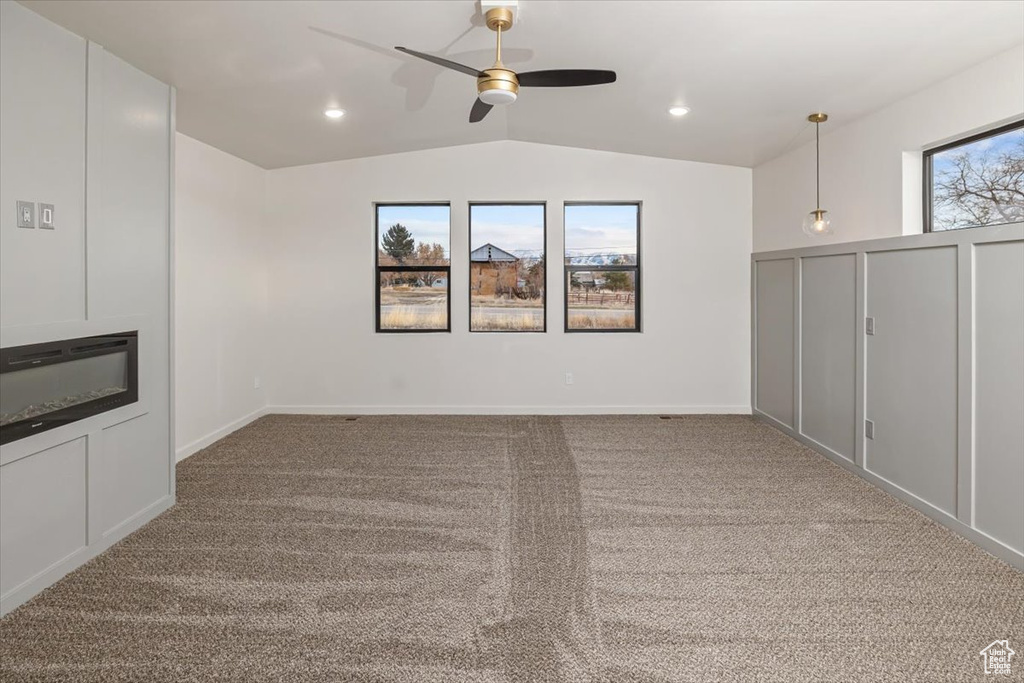 Basement featuring light carpet and ceiling fan