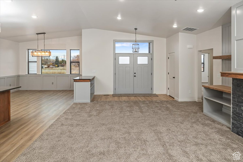 Entryway featuring light hardwood / wood-style floors and vaulted ceiling