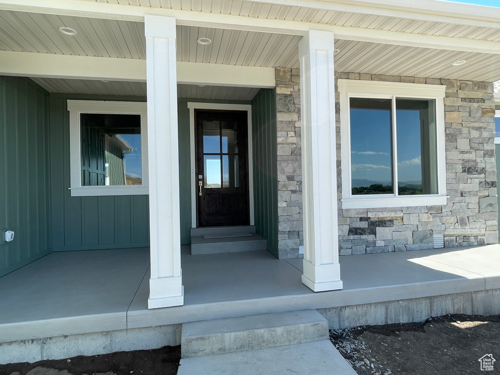 Doorway to property featuring a porch