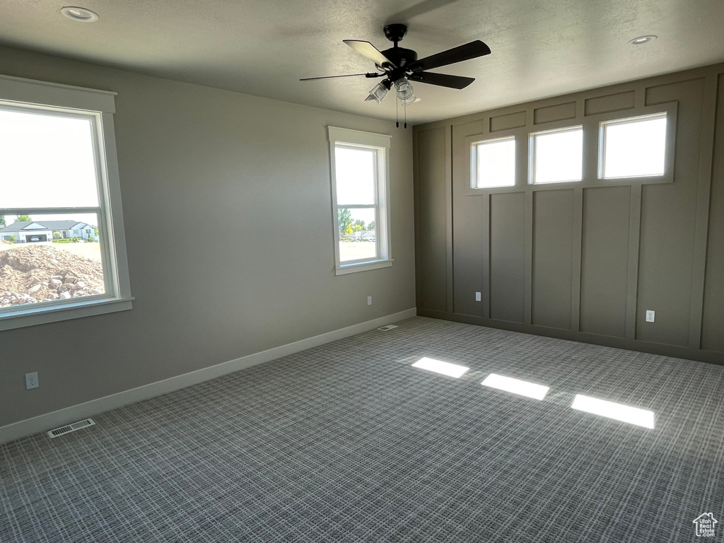 Empty room featuring ceiling fan