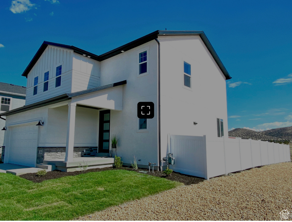 Exterior space with a front lawn and a garage