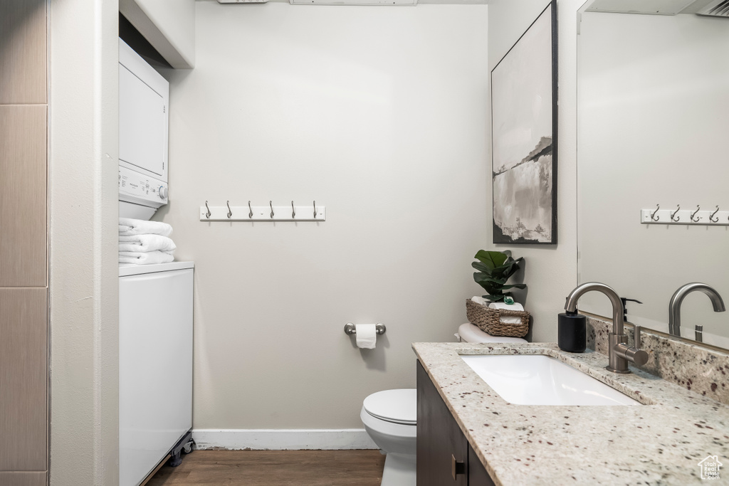 Bathroom with vanity, wood-type flooring, and toilet