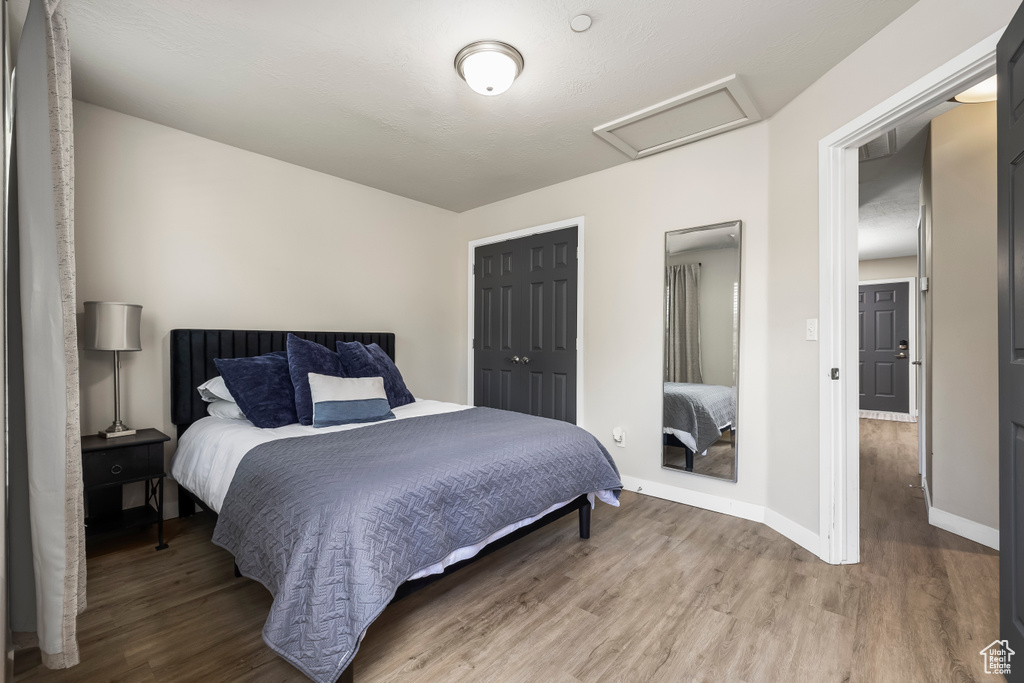 Bedroom featuring hardwood / wood-style floors and a closet