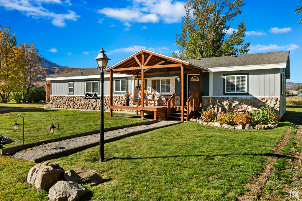 Ranch-style home featuring a front yard