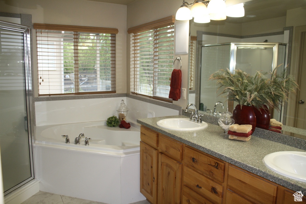 Bathroom featuring vanity and independent shower and bath