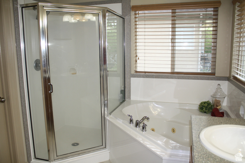 Bathroom with vanity and separate shower and tub