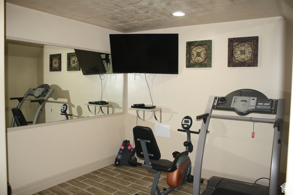 Exercise area featuring a textured ceiling