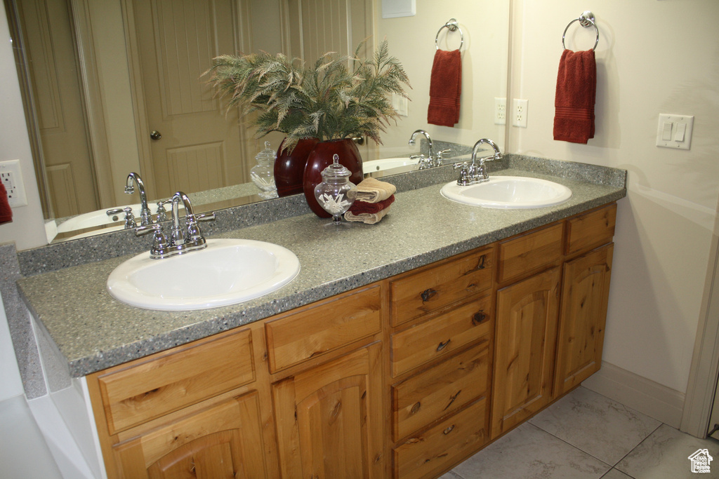 Bathroom with tile patterned flooring and vanity