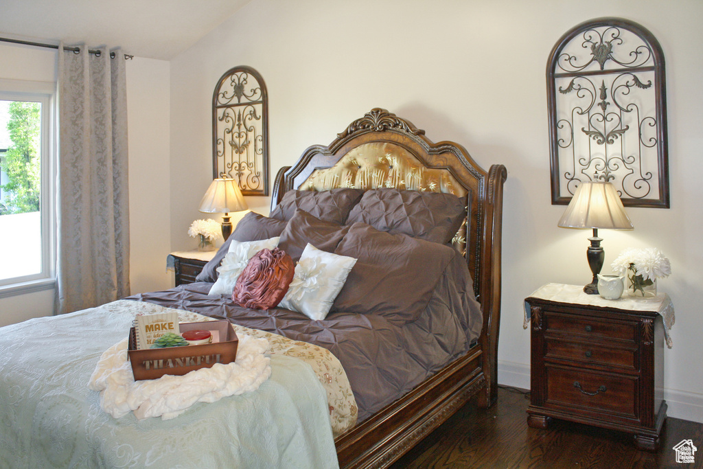 Bedroom with dark hardwood / wood-style floors and vaulted ceiling