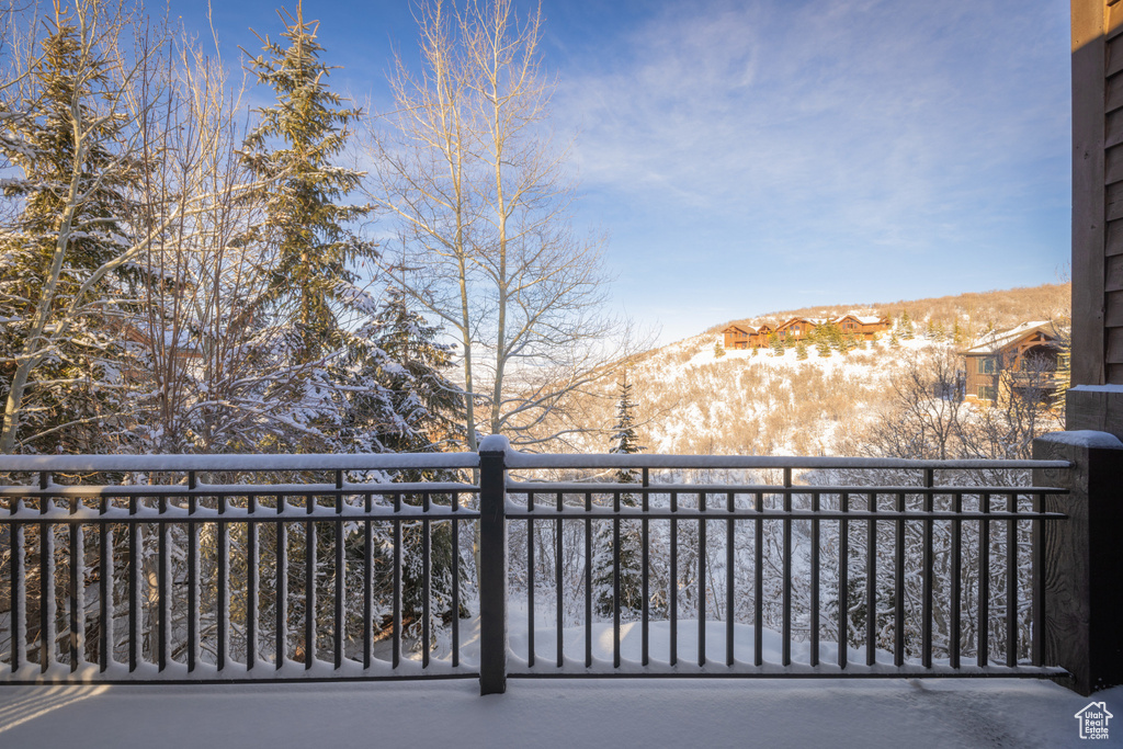 Snow covered back of property with a mountain view