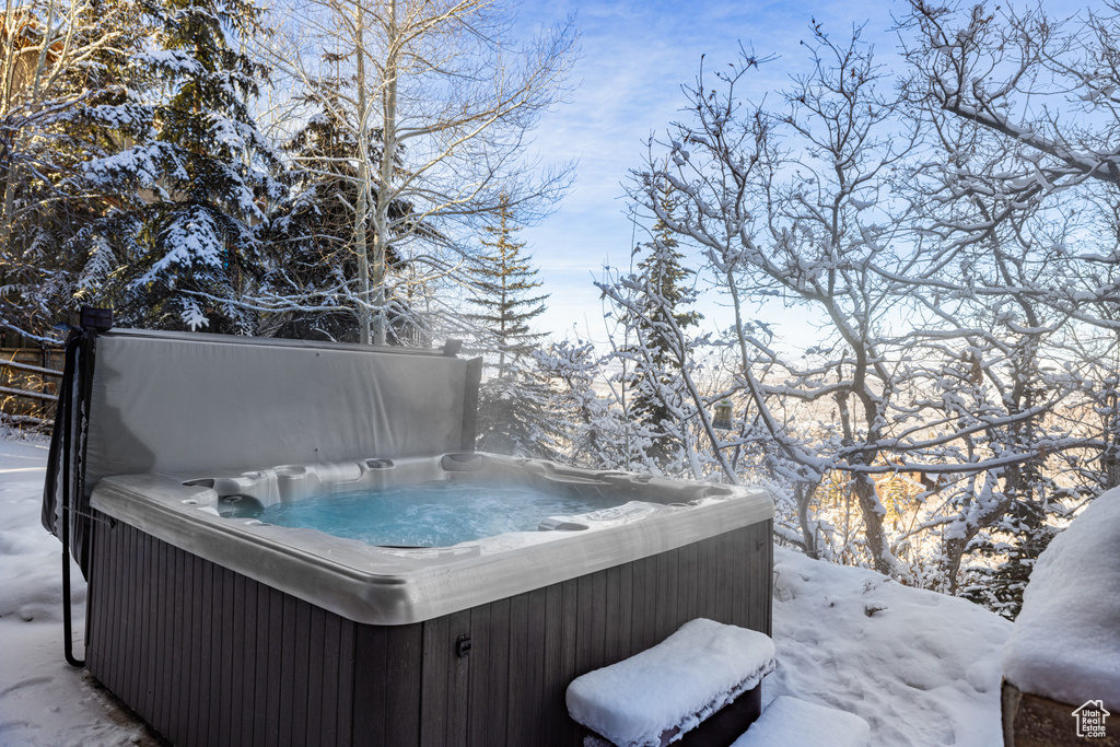 Snow covered deck with a hot tub