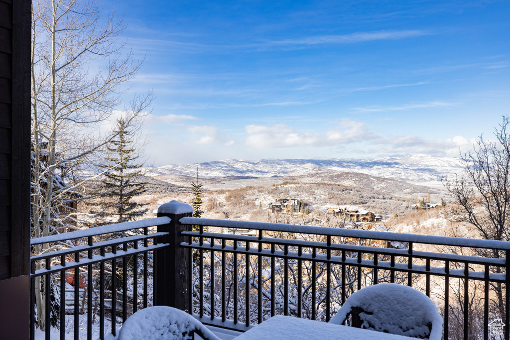 Snow covered back of property featuring a mountain view