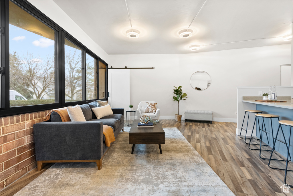 Living room featuring wood-type flooring and a barn door