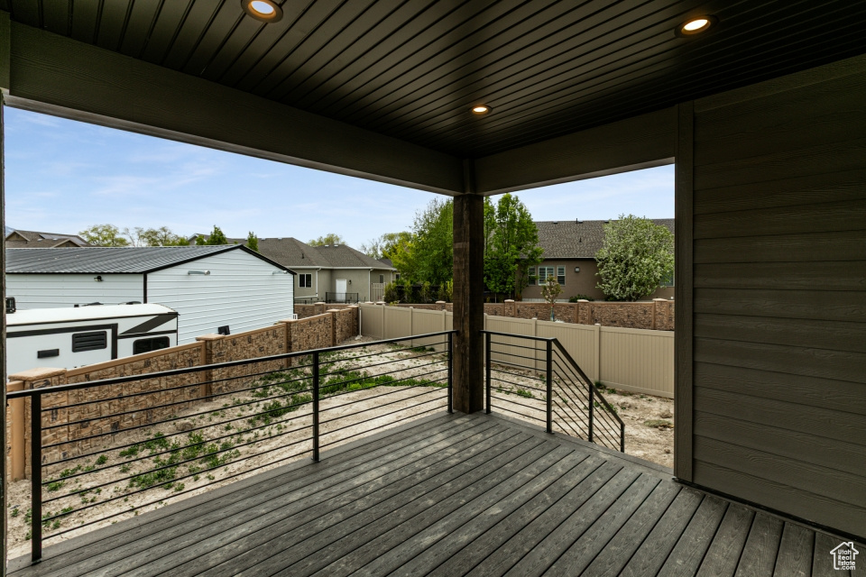 Wooden deck featuring fence and a residential view