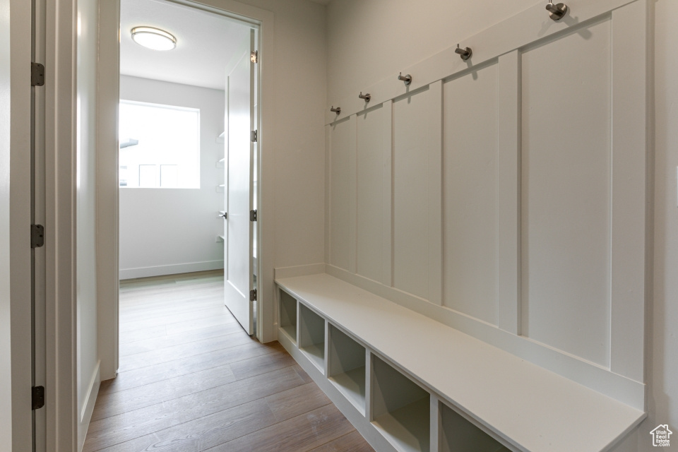 Mudroom featuring baseboards and light wood-style flooring
