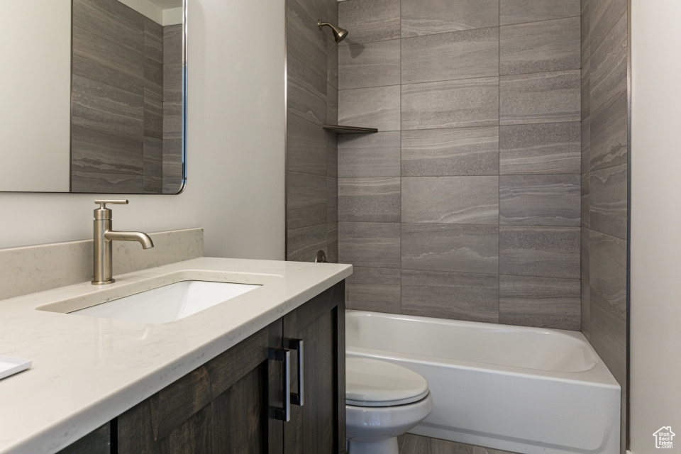 Full bathroom featuring toilet, shower / bathing tub combination, and vanity