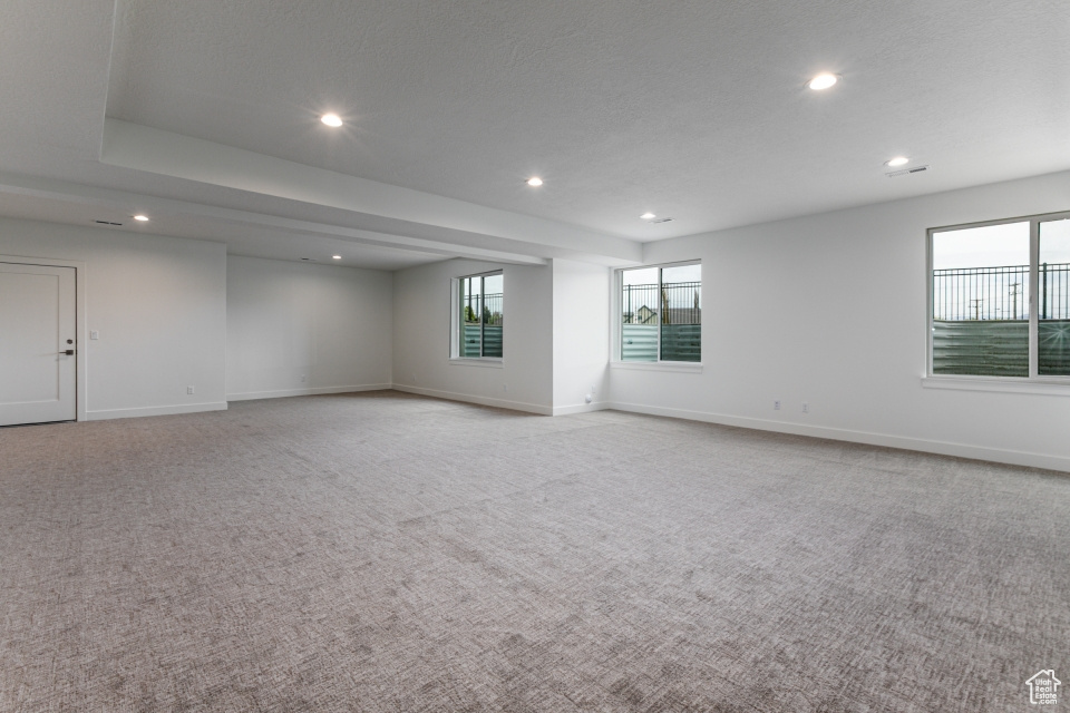 Empty room featuring recessed lighting and light colored carpet