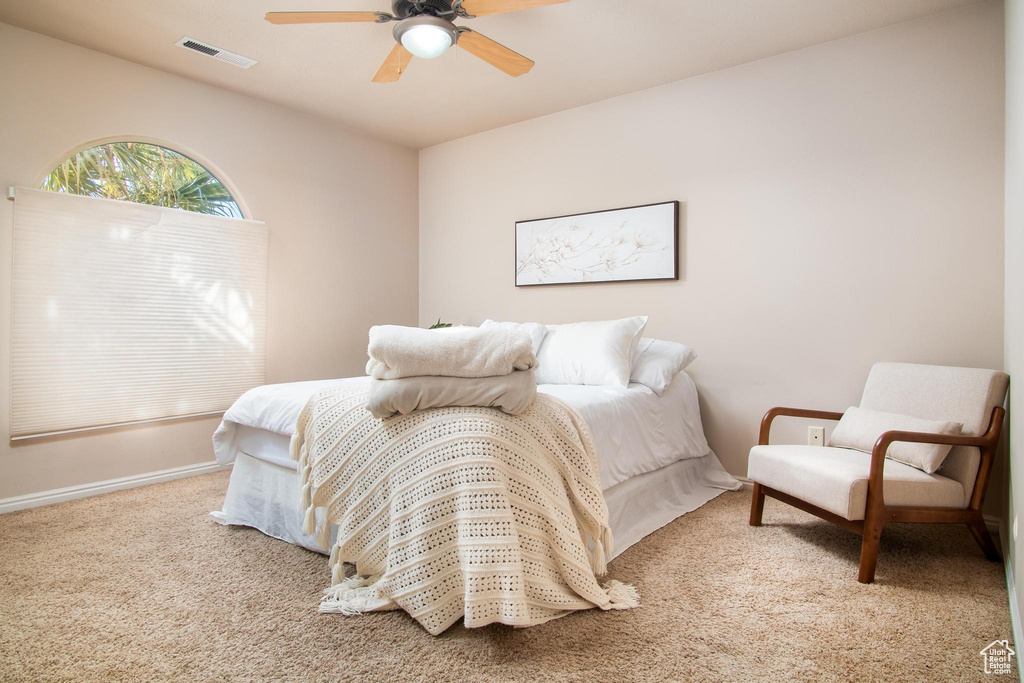Bedroom with ceiling fan and carpet