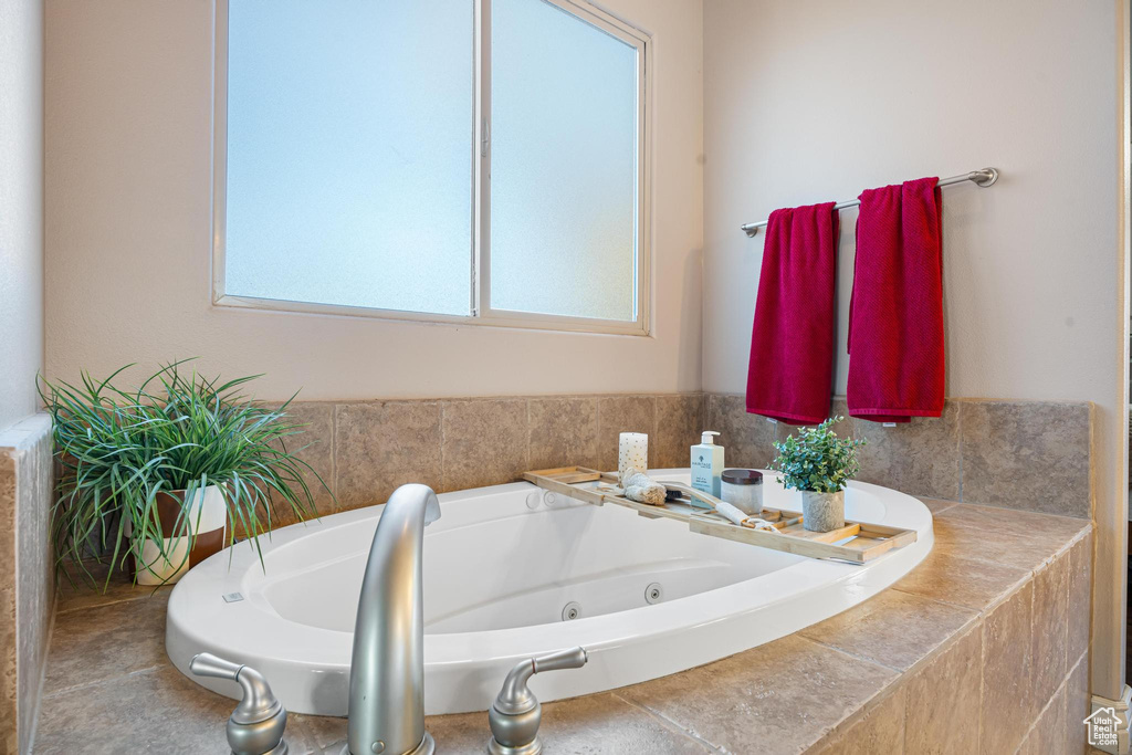 Bathroom featuring a wealth of natural light and a bathing tub