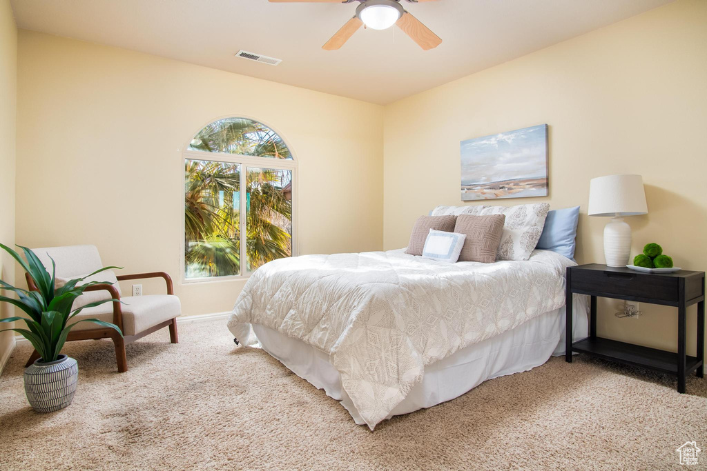 Bedroom with ceiling fan and carpet floors