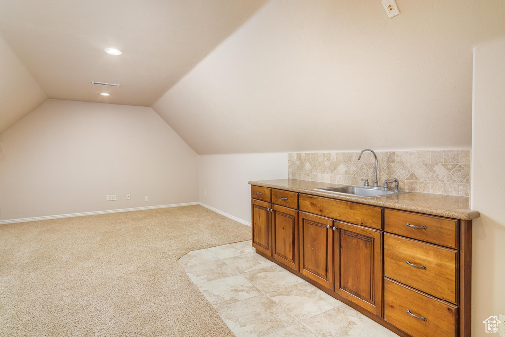 Bathroom with sink and vaulted ceiling