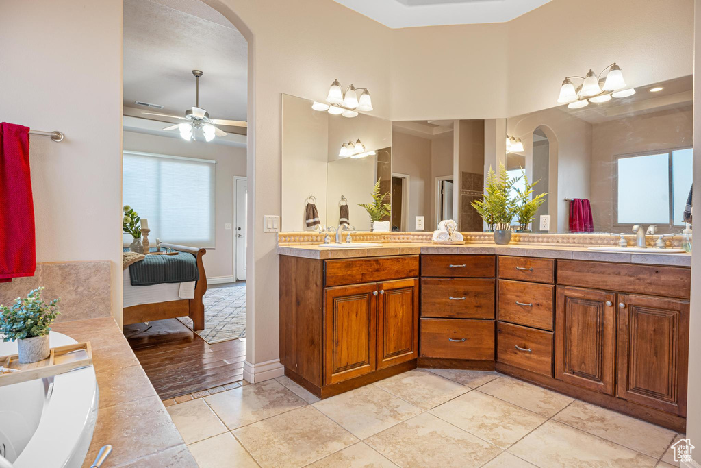 Bathroom featuring vanity, tile patterned floors, and ceiling fan