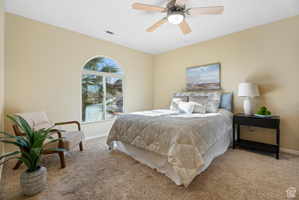 Carpeted bedroom with ceiling fan