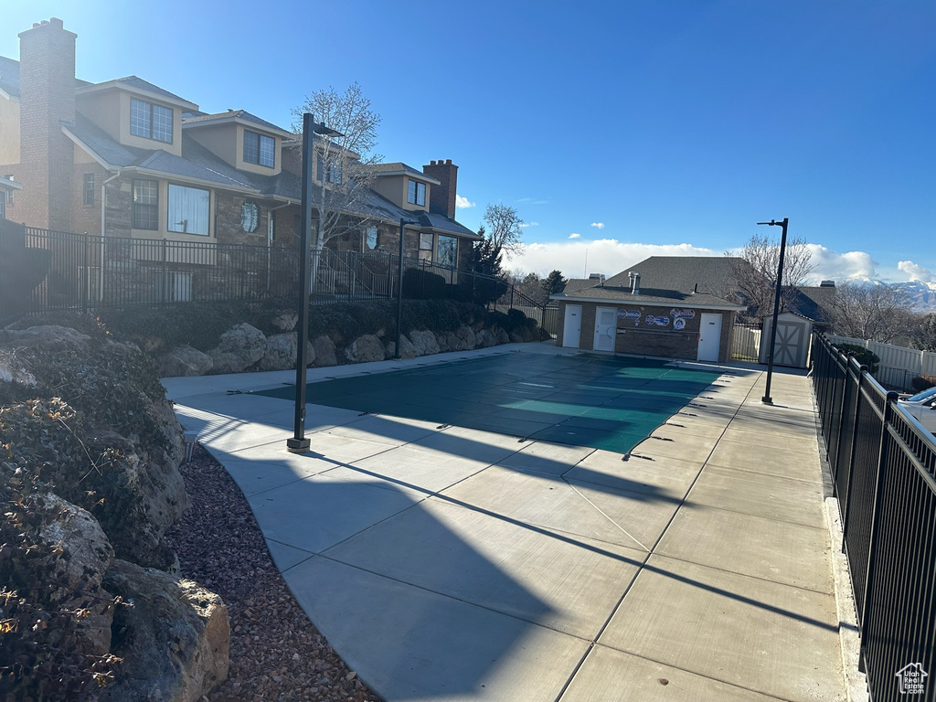 View of swimming pool featuring an outbuilding