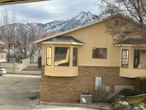 View of front of house featuring central AC unit and a mountain view