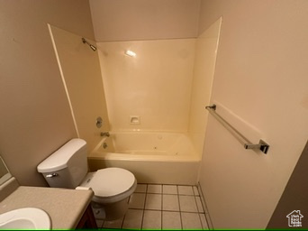 Full bathroom with tile patterned flooring, vanity, toilet, and  shower combination