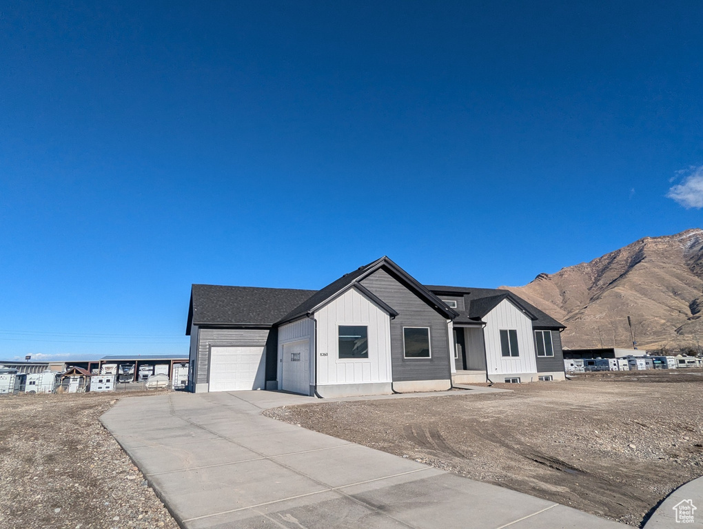 View of front of property featuring a mountain view and a garage