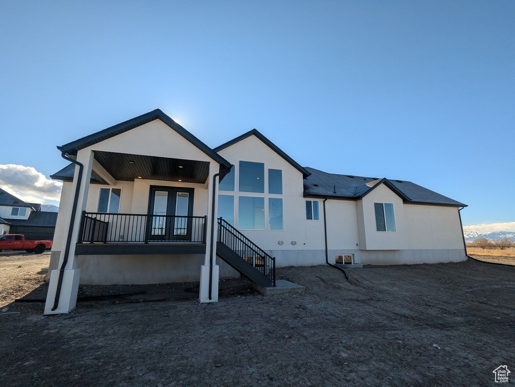 Rear view of property with covered porch