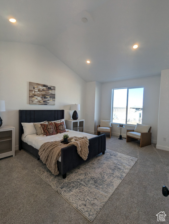 Carpeted bedroom featuring lofted ceiling