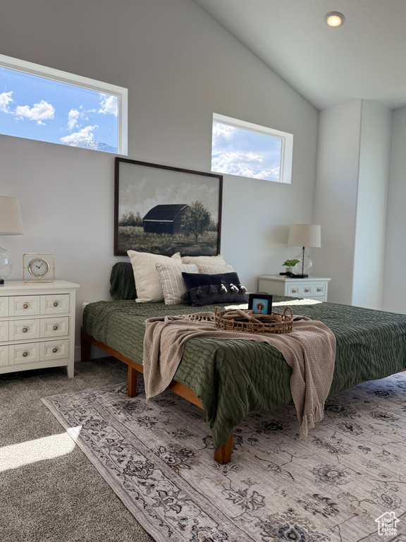 Carpeted bedroom with recessed lighting and vaulted ceiling