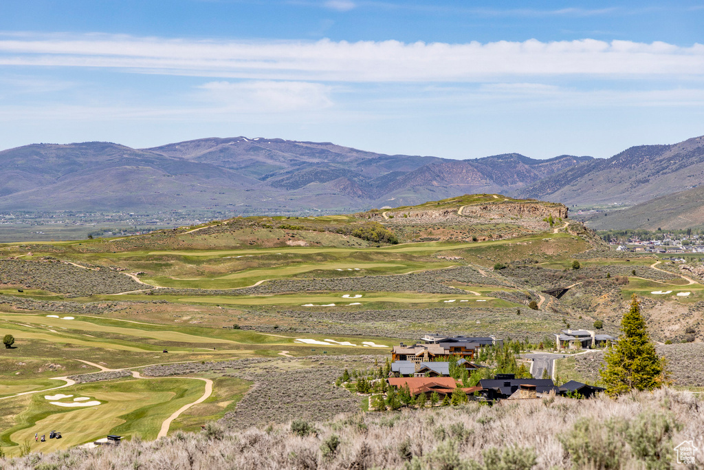 Property view of mountains with view of golf course