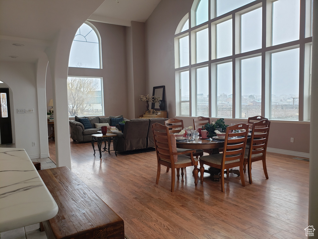 Dining room featuring hardwood / wood-style flooring and a high ceiling