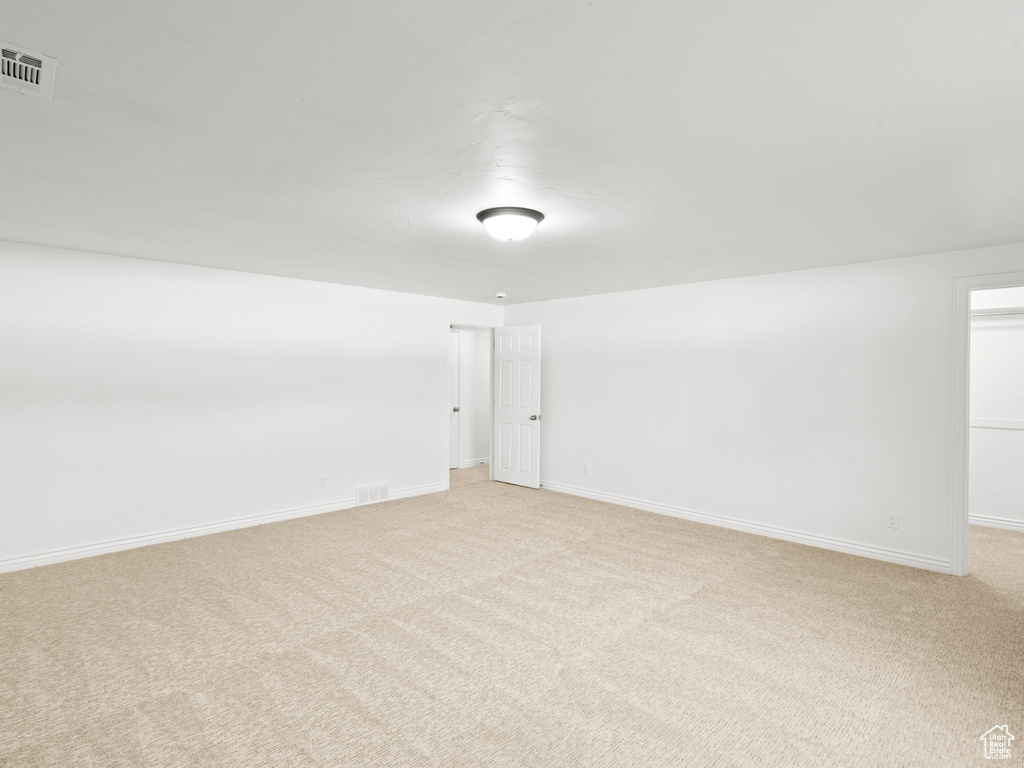 Unfurnished room with light colored carpet