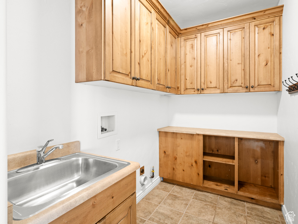 Laundry room featuring washer hookup, gas dryer hookup, cabinets, and sink