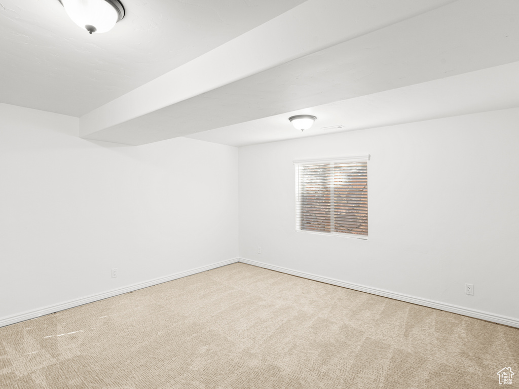 Spare room featuring light colored carpet