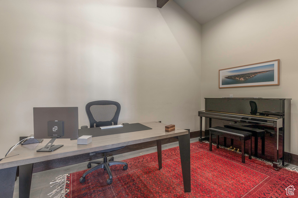 Office area featuring vaulted ceiling